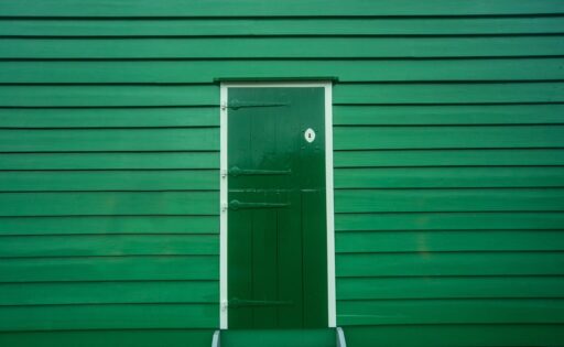Een authentieke jaren 30 voordeur met glas-in-lood en donker hardhout kozijn