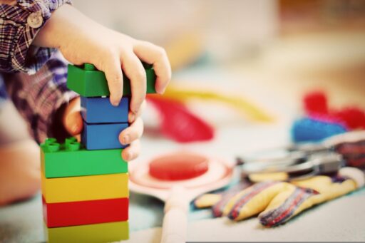 Roze houten blokken gestapeld tot een piramide, het klassieke Montessori-materiaal