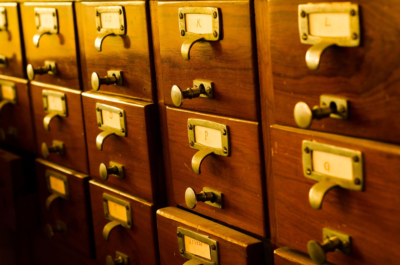 Een houten kaartenbak met kleine lades, zoals die vroeger in schoolbibliotheken te vinden was